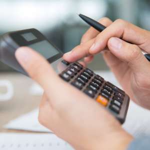 Male hands using calculator